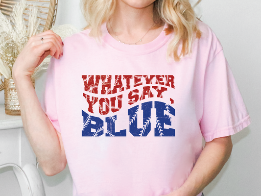 a woman wearing a pink shirt that says whatever you say blue