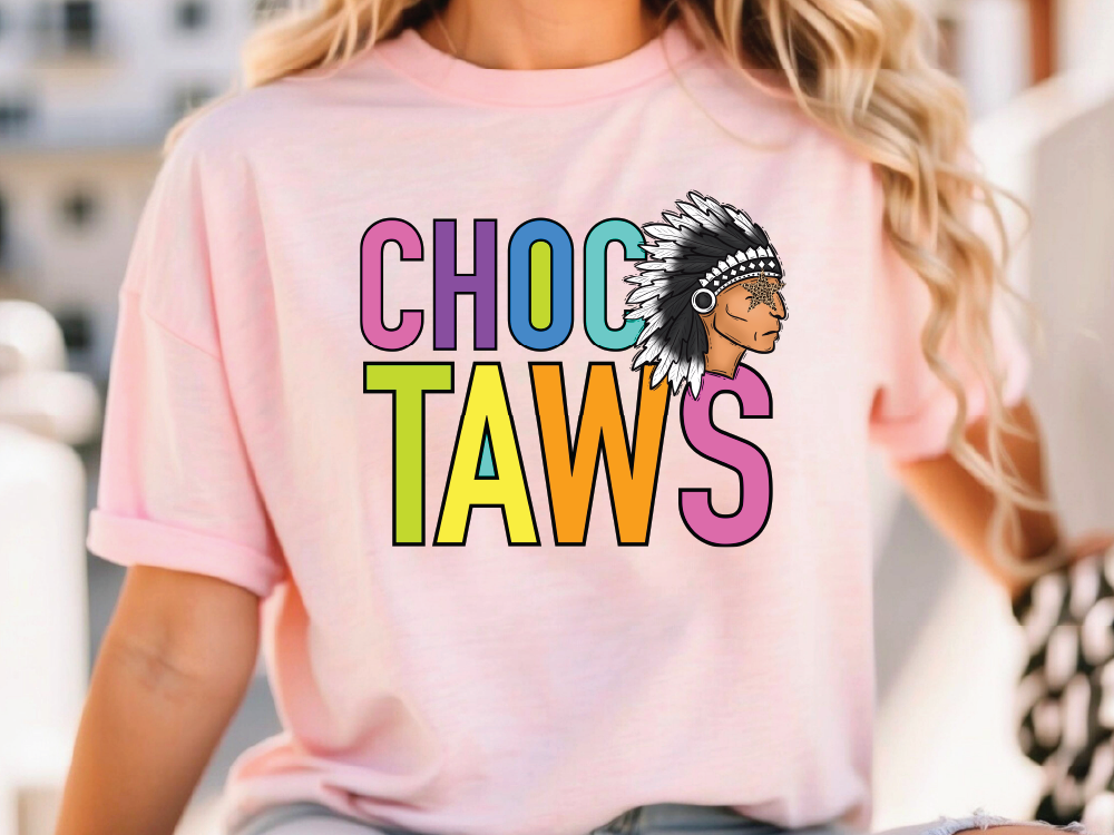A woman wearing a pink t-shirt with the text "CHOC TAWS" printed on it.