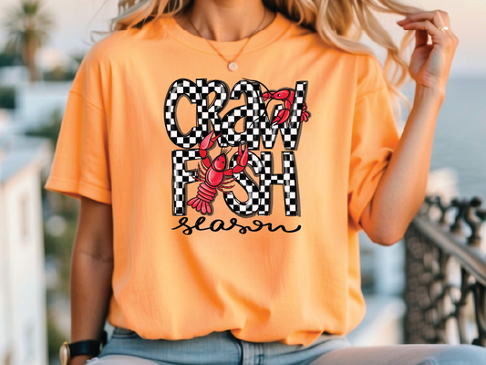 a woman wearing an orange shirt with a crab on it