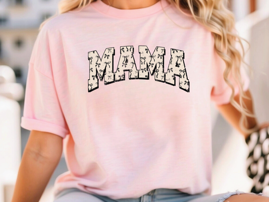 a woman wearing a pink shirt with the word mama printed on it