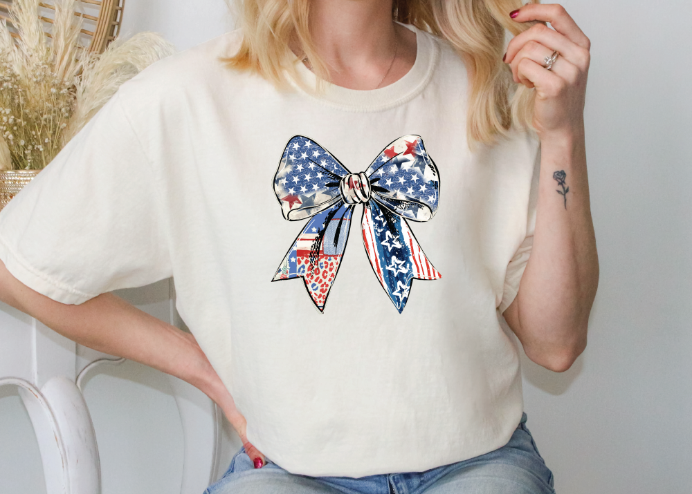 a woman wearing a patriotic bow t - shirt