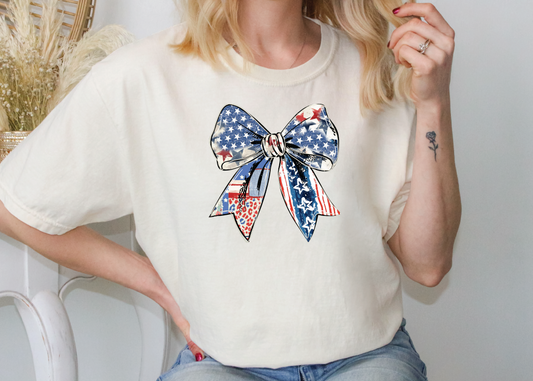 a woman wearing a patriotic bow t - shirt