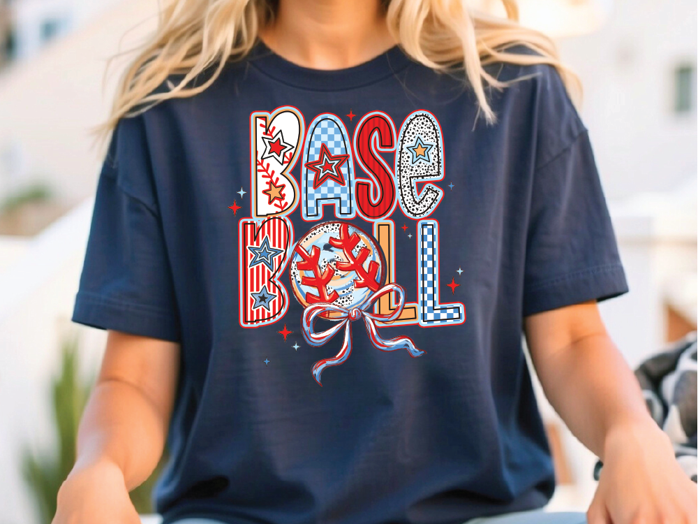 a woman sitting on a bench wearing a baseball t - shirt