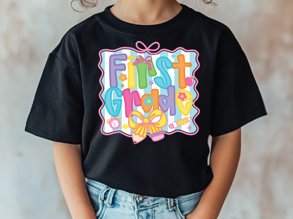 a young girl wearing a black t - shirt that says first grade