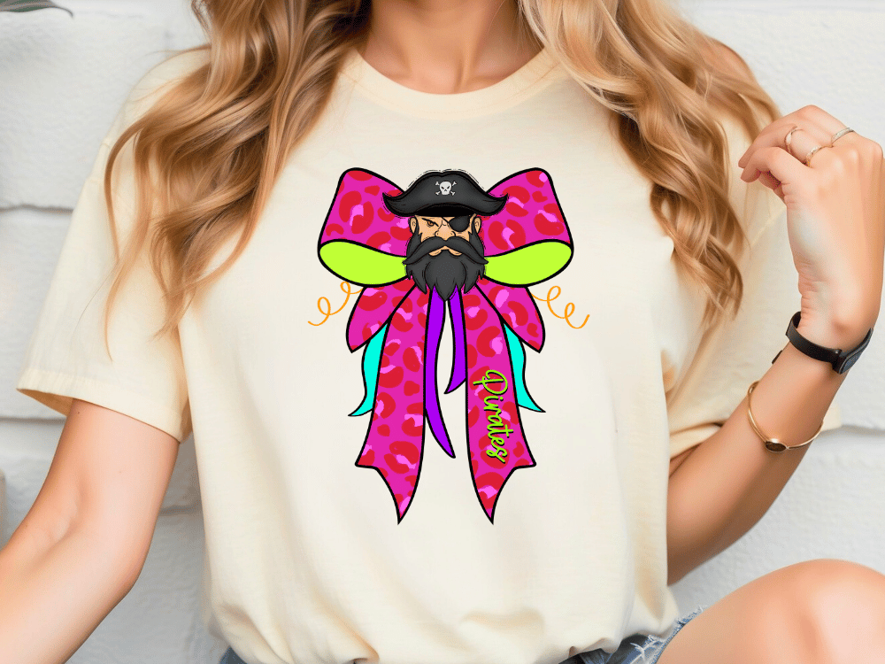A woman wearing a white t-shirt with a colorful graphic design of a pirate face and a bow on it.