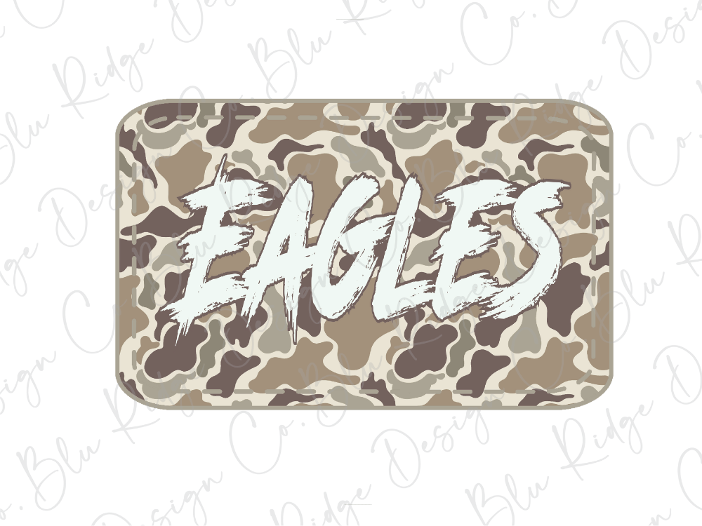 A camouflage-patterned object with the word "EAGLES" written on it in a stylized, graffiti-like font.