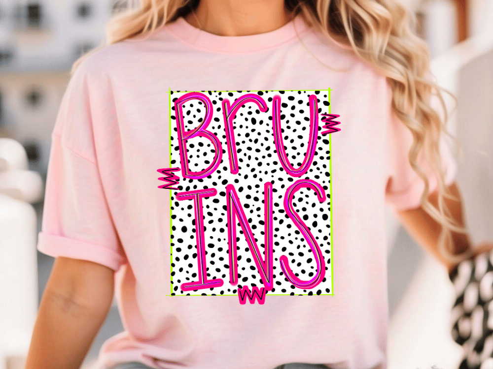 A woman wearing a pink t-shirt with the word "BRUINS" printed on it in pink and black polka dot letters.
