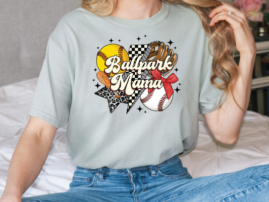 a woman sitting on top of a bed wearing a t - shirt