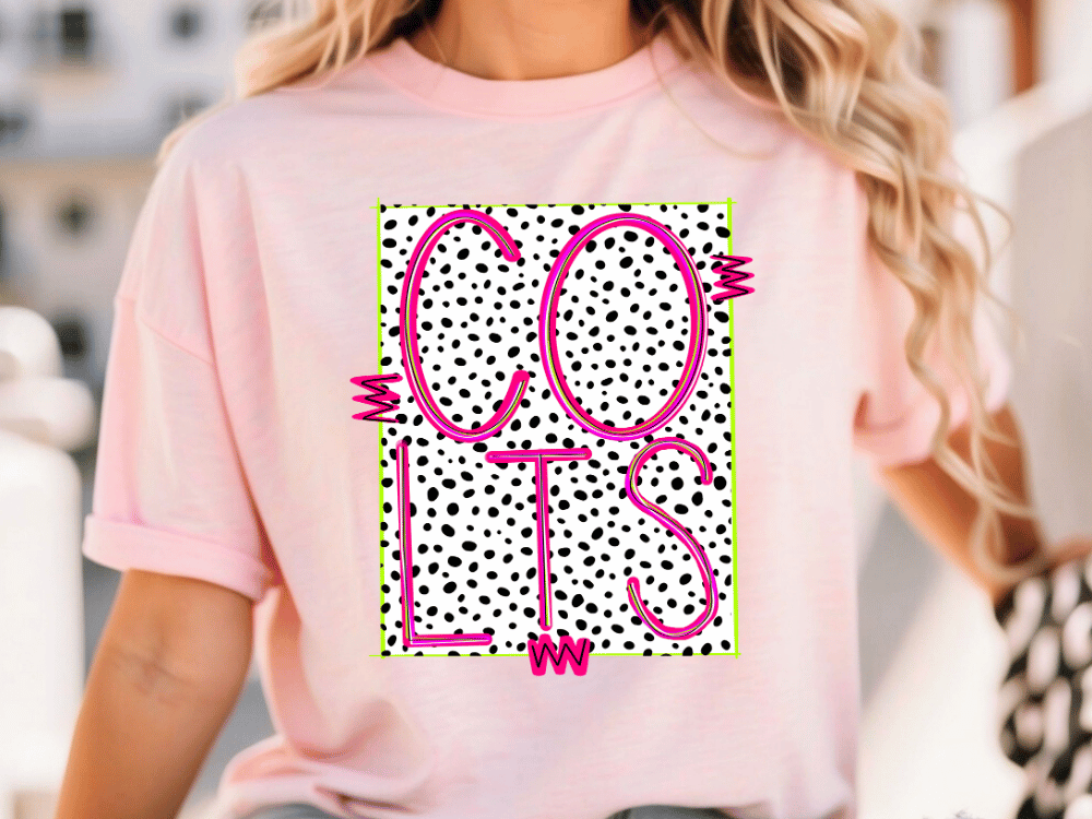 A woman wearing a pink t-shirt with a graphic design featuring the word "COLTS" in pink and black, with a polka dot pattern.