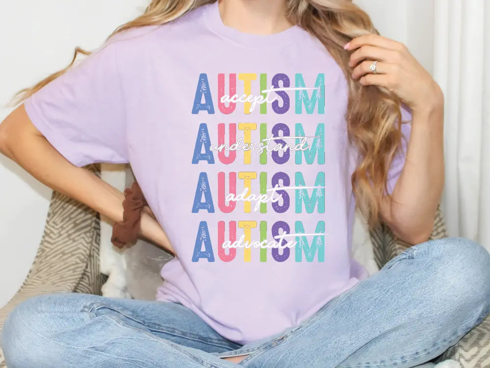 a woman sitting on a bed wearing a purple shirt