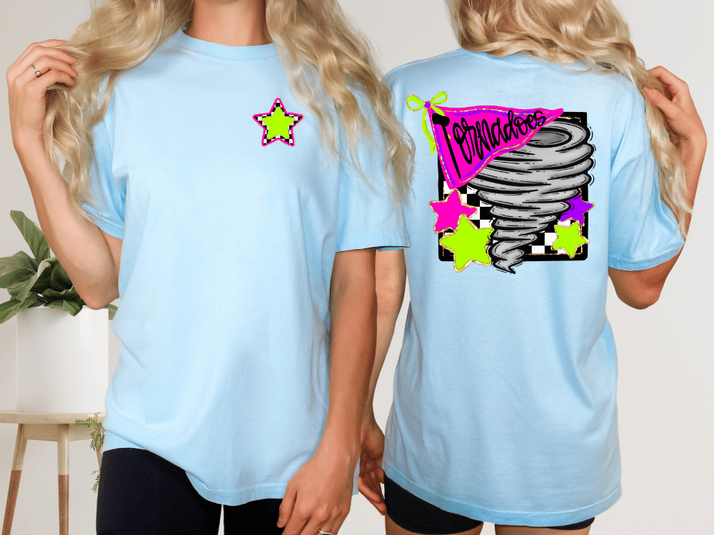 A woman wearing a light blue t-shirt with a graphic design on the back, including a star, a tornadoes graphic, and colorful stars.
