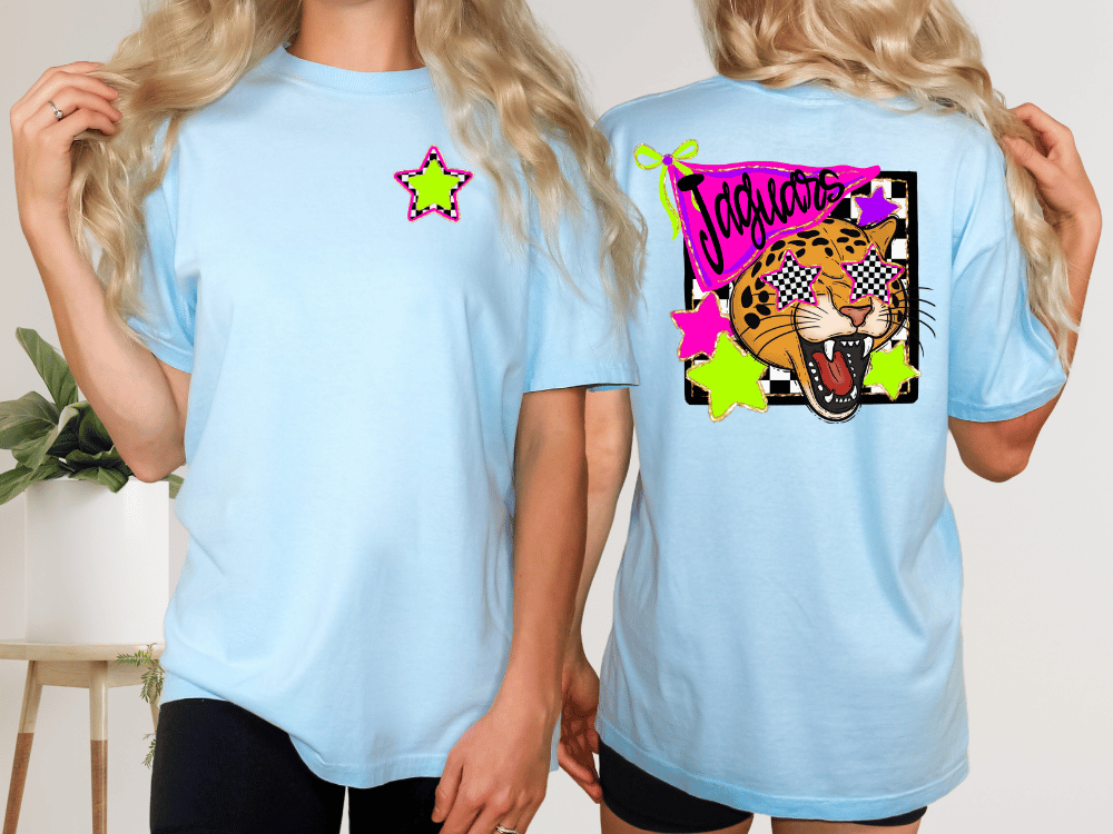 A woman wearing a light blue t-shirt with a graphic design on the back, including a leopard and colorful stars.