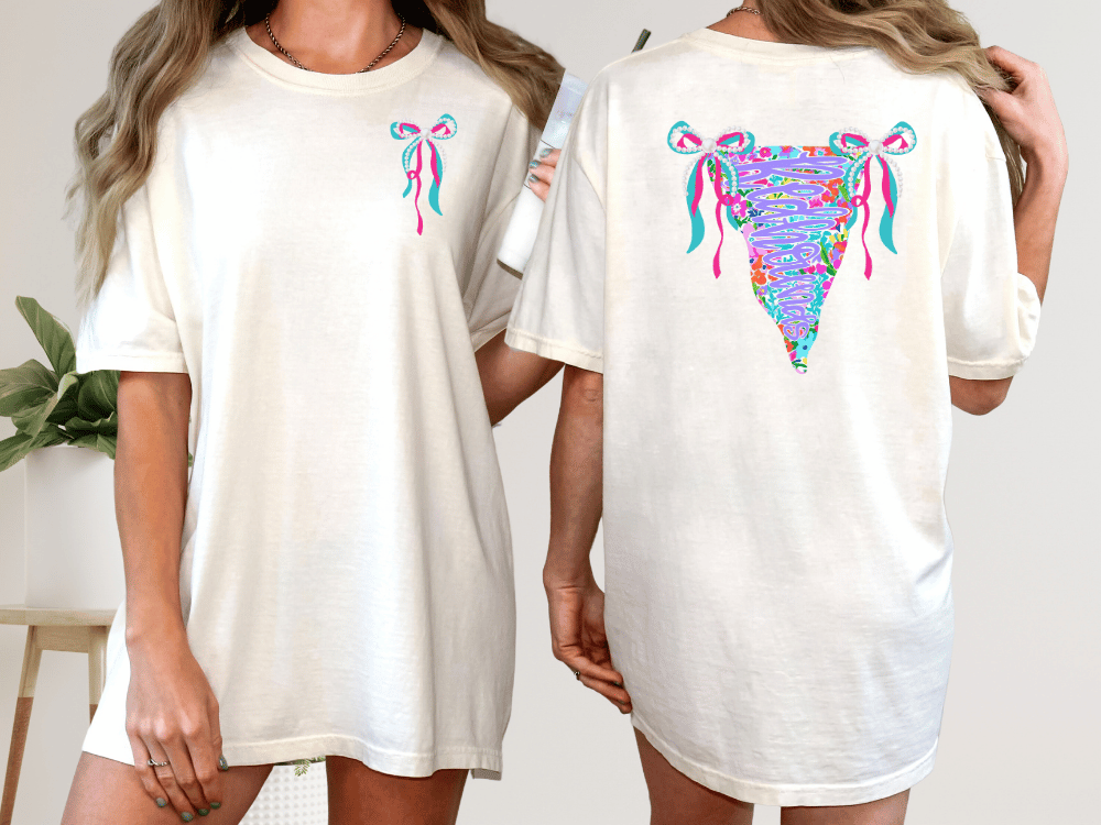 two women wearing white t-shirts with colorful, abstract designs on the back.
