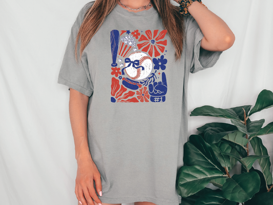 a woman wearing a gray t - shirt with a baseball on it