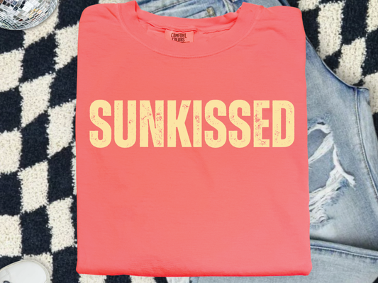 a red shirt that says sunk kissed on it