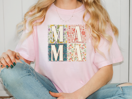 a woman wearing a pink t - shirt with the word ma ma on it