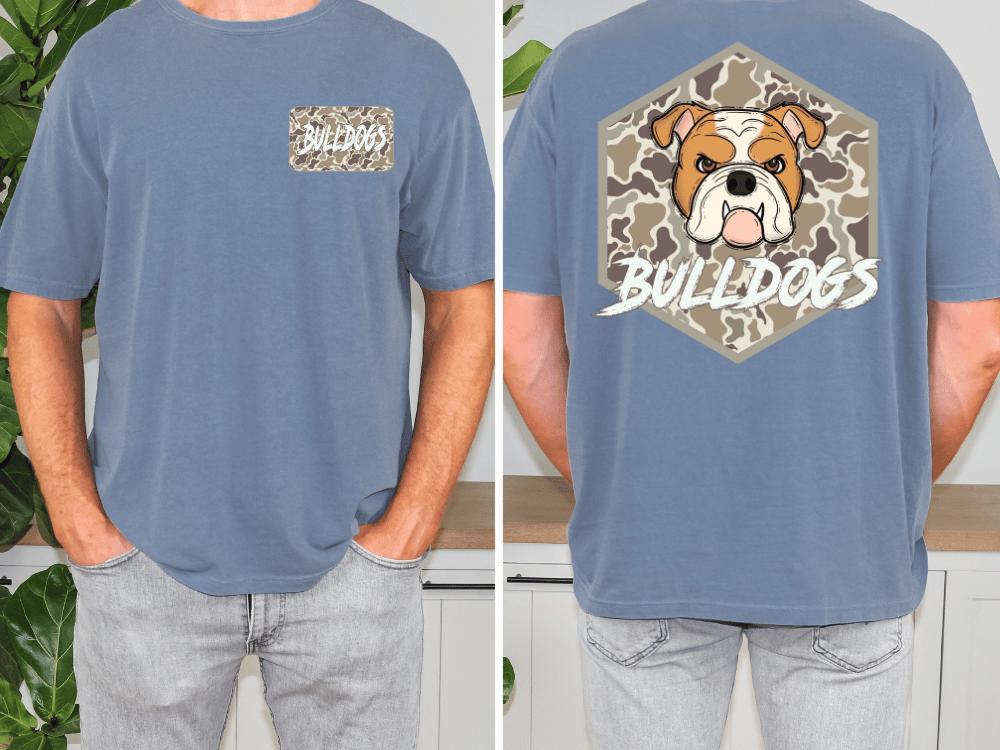 a man wearing a blue t-shirt with a graphic of a bulldog and the word "Bulldogs" printed on it. The t-shirt has a camouflage pattern on the front and a hexagon with the bulldog's face on the back.