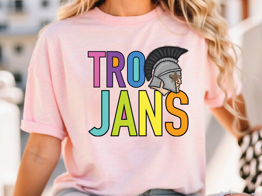 A woman wearing a pink t-shirt with the text "TRO JANS" printed on it.