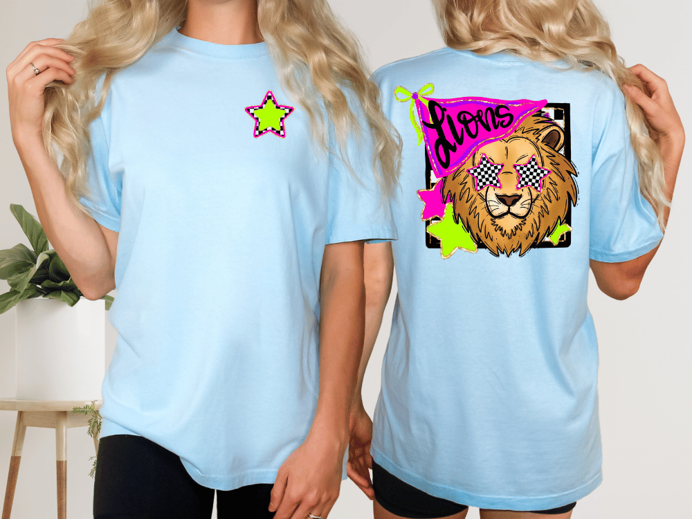 two women wearing light blue t-shirts with a graphic design featuring a lion wearing sunglasses and a star.