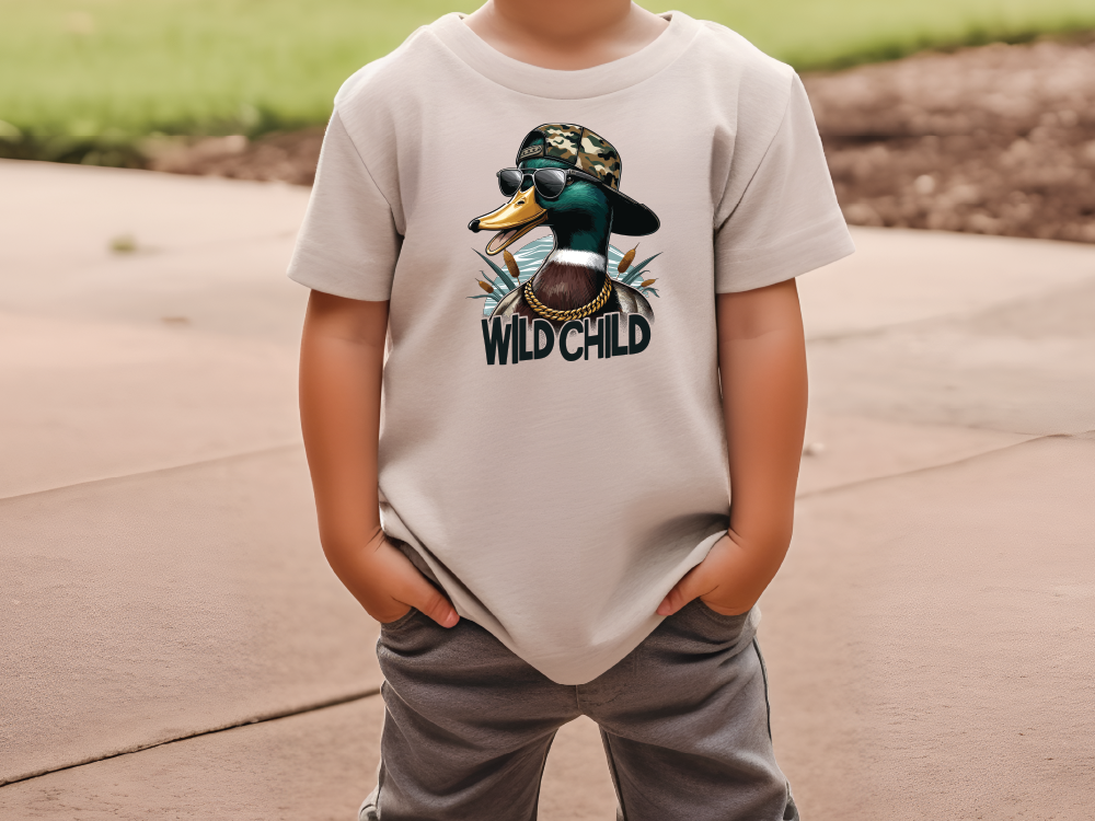 a young boy wearing a t - shirt with a duck on it