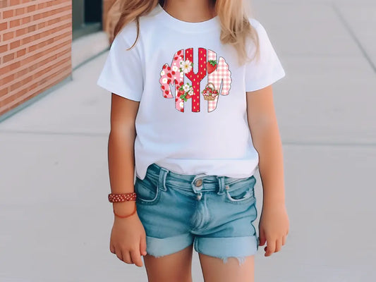 a little girl wearing a white shirt and denim shorts