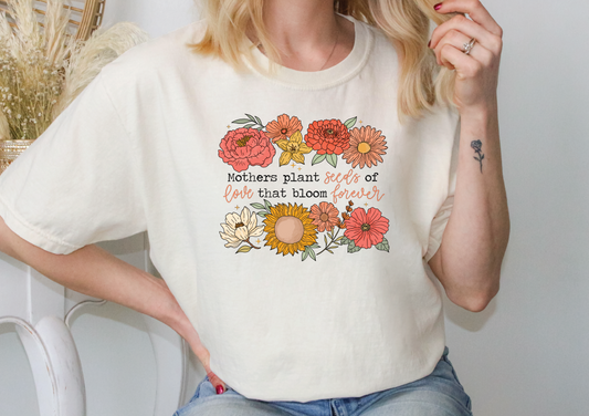 a woman wearing a t - shirt with flowers on it