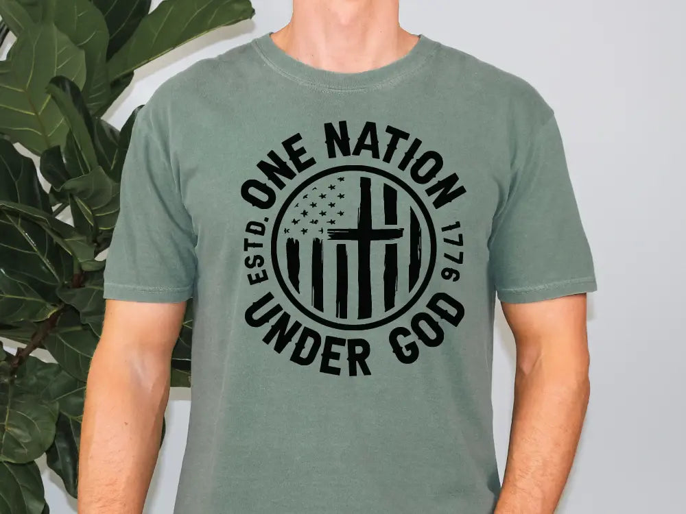 a man wearing a green shirt with a cross on it