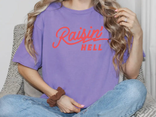 a woman sitting on a couch with her hair in a ponytail