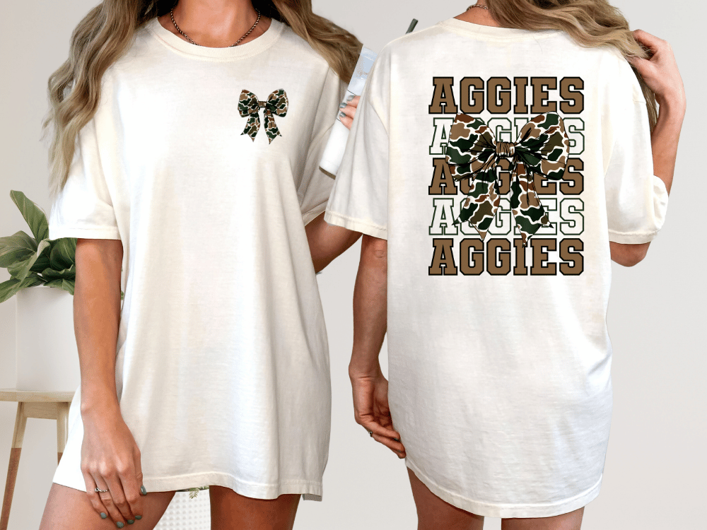 A woman wearing a white t-shirt with a bow and the word "Aggies" printed on the back.