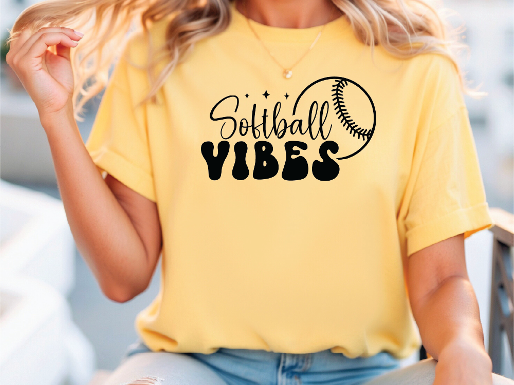 a woman wearing a softball vibes t - shirt