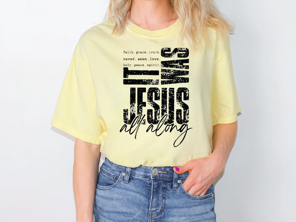 A woman wearing a yellow t-shirt with a graphic design featuring text and a Bible verse.