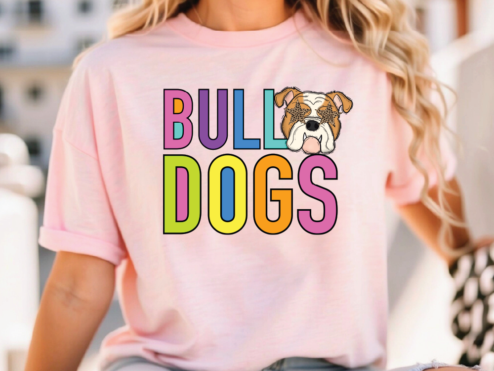 A woman wearing a pink t-shirt with the text "Bulldogs" and an illustration of a bulldog's face.