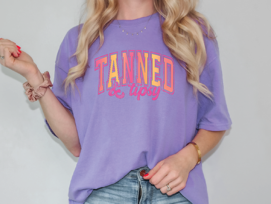 a woman with blonde hair wearing a purple shirt