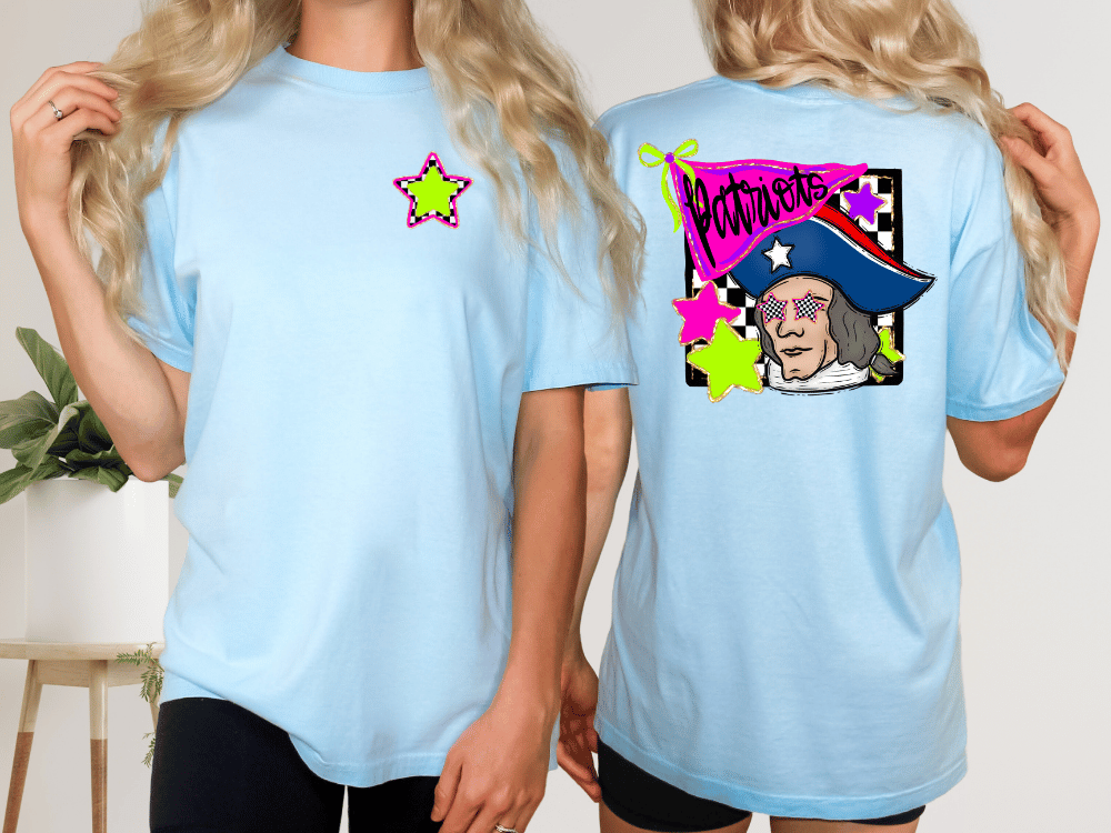 A woman wearing a light blue t-shirt with a graphic design on the back, including a cartoon character and text.