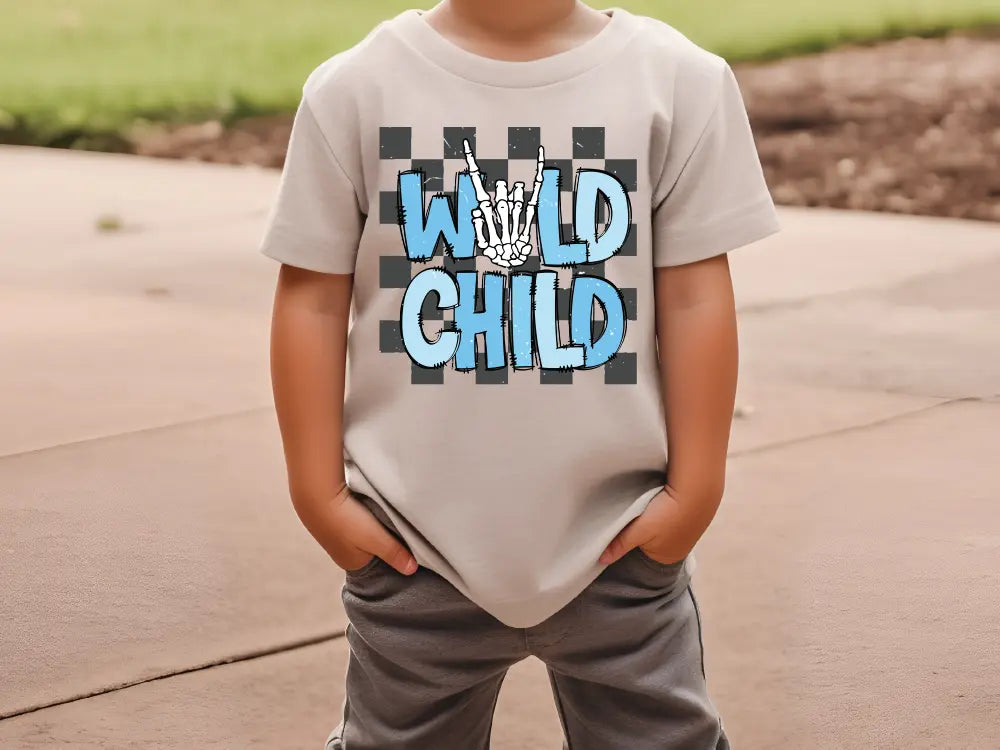 a young boy wearing a t - shirt that says wild child