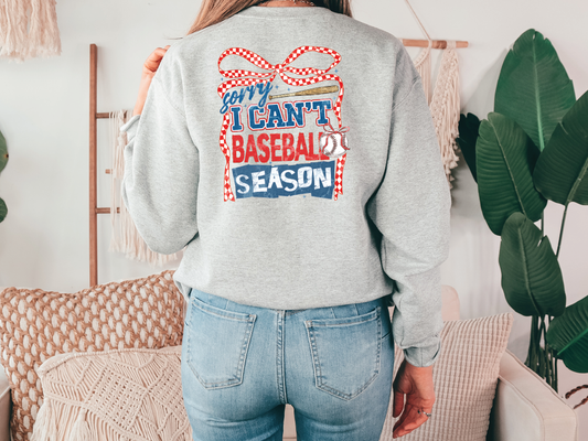a woman wearing a sweatshirt that says i can't baseball season