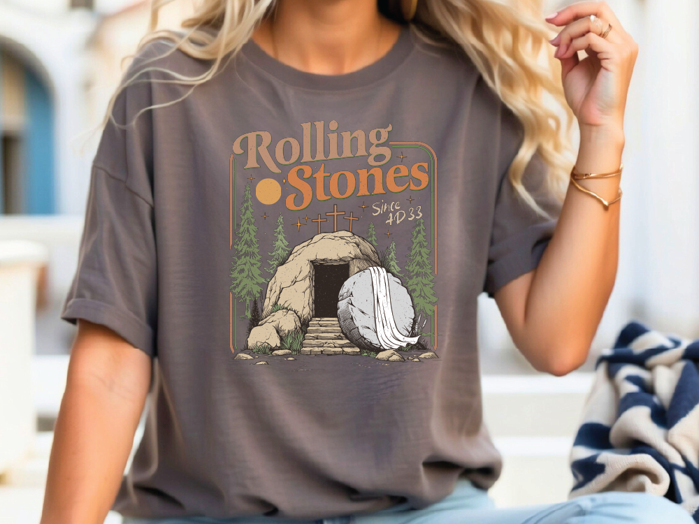 a woman sitting on a bench wearing a rolling stones t - shirt