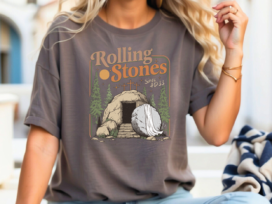 a woman sitting on a bench wearing a rolling stones t - shirt
