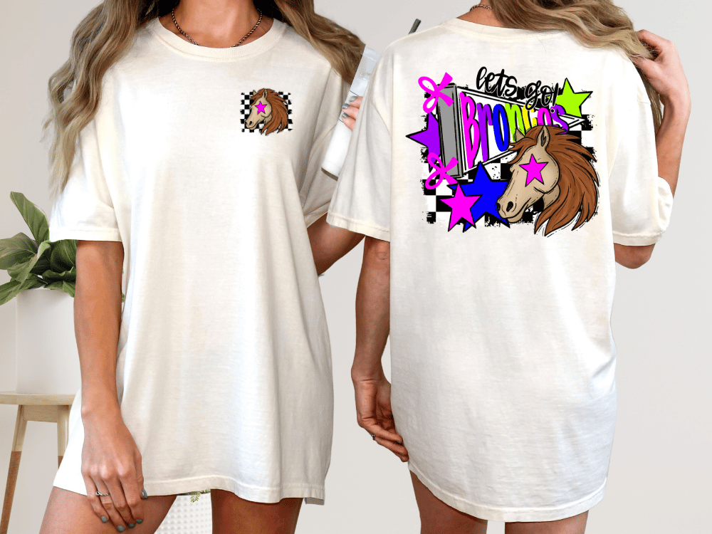 A woman wearing a white t-shirt with a graphic design on the back, featuring a unicorn and colorful stars.
