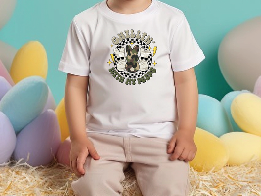 a little boy sitting in front of a bunch of balloons