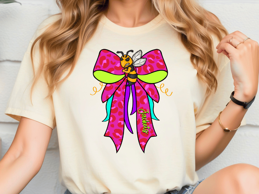 A woman wearing a white t-shirt with a colorful graphic of a bee on it.