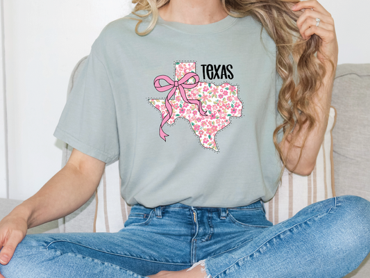 a woman sitting on a couch wearing a texas t - shirt