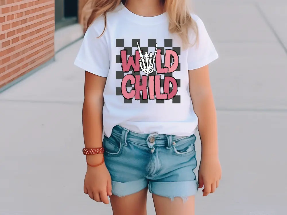 a little girl wearing a white shirt and denim shorts