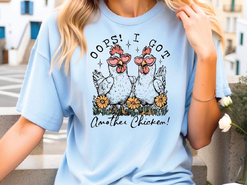 a woman wearing a blue shirt with two chickens on it