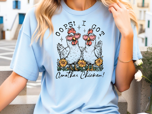 a woman wearing a blue shirt with two chickens on it