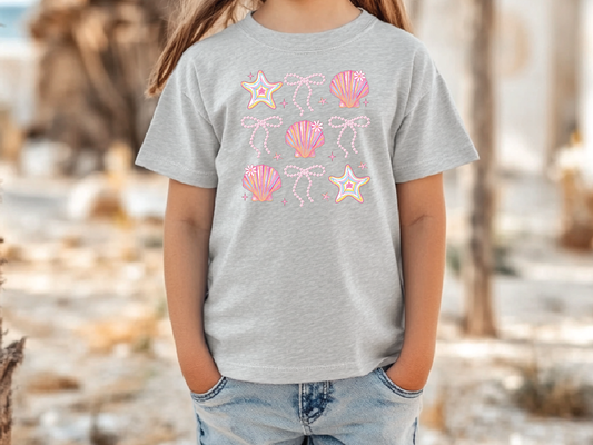 a little girl standing next to a tree