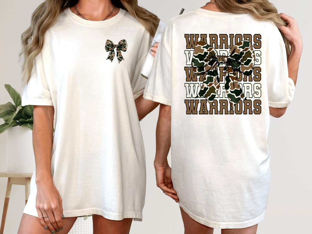 A woman wearing a white t-shirt with a camouflage pattern and the text "WARRIORS" printed on the back.