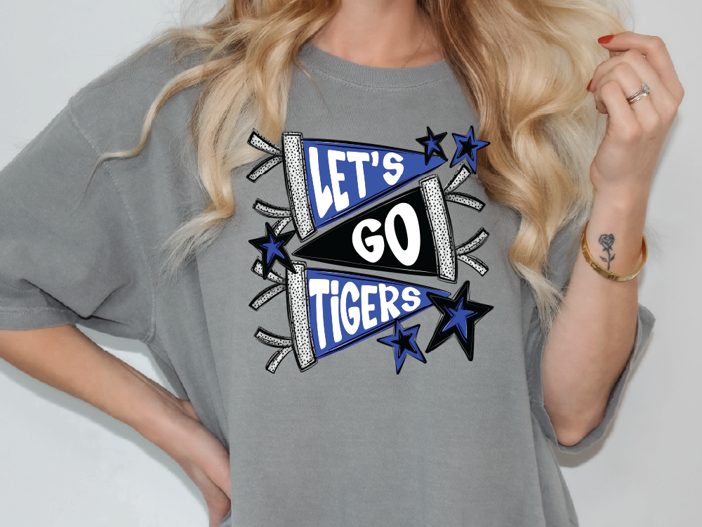 A woman wearing a gray t-shirt with a graphic design that says "Let's go Tigers".