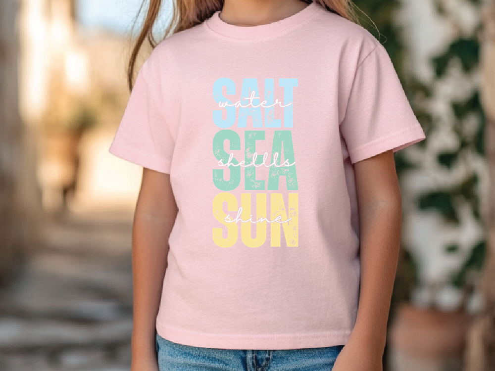 a little girl wearing a pink shirt and jeans
