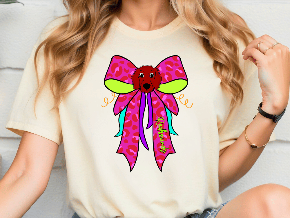 A woman wearing a white t-shirt with a colorful bow design on it.